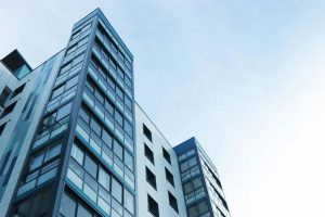 pexels photo 323705 323705 Low-angle view of a modern glass skyscraper against a clear sky in Poole, UK.